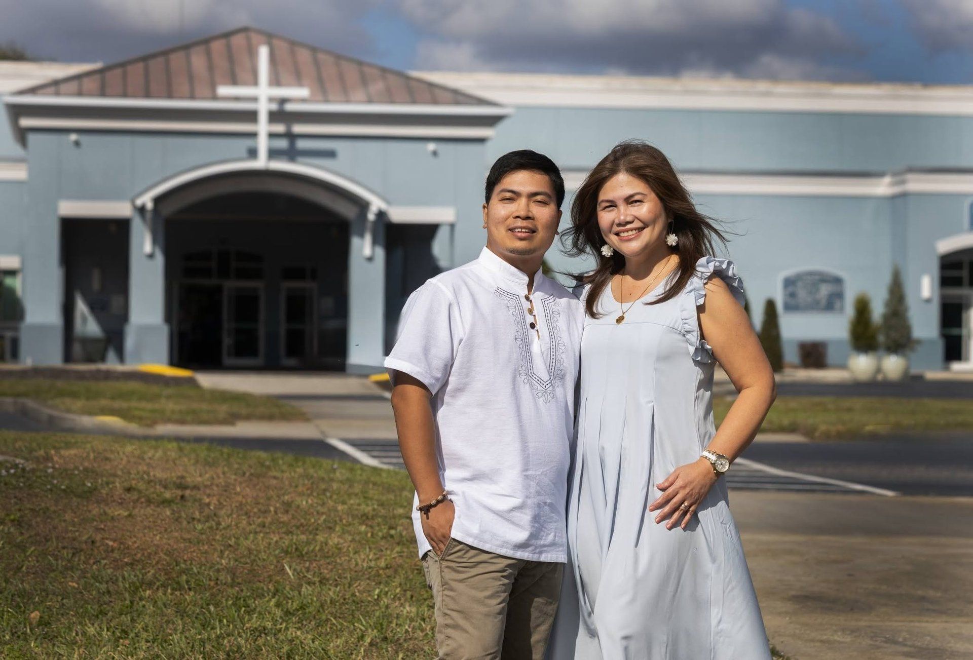 Rochelle and Nathaniel in white at the church for their ten-year vow renewal, 2026